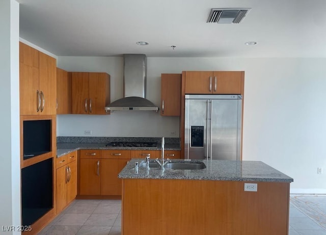 4575 Dean Martin Dr Unit 3206, Las Vegas, NV 89103 - kitchen featuring wall chimney exhaust hood, stainless steel appliances, a sink, brown cabinetry, and recessed lighting