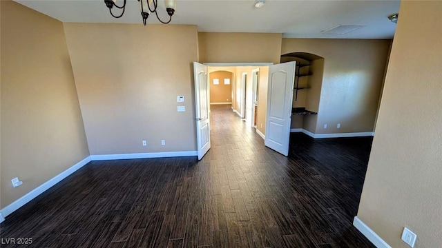 8159 Base Camp Ave, Las Vegas, NV 89178 - unfurnished room with arched walkways and dark wood-type flooring