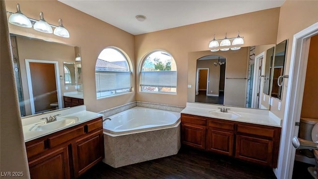 8159 Base Camp Ave, Las Vegas, NV 89178 - bathroom with toilet, wood finished floors, a garden tub, and two vanities