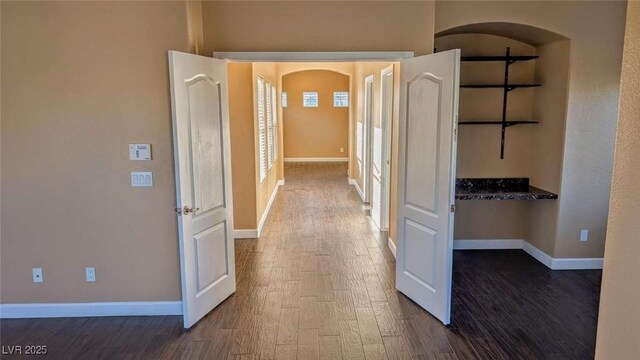8159 Base Camp Ave, Las Vegas, NV 89178 - hallway with dark wood finished floors and arched walkways