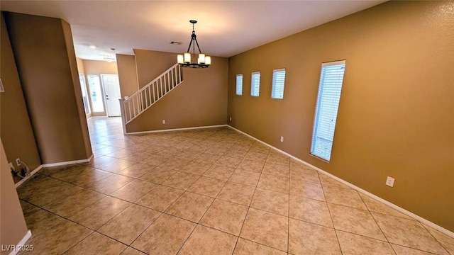 8159 Base Camp Ave, Las Vegas, NV 89178 - spare room featuring healthy amount of natural light, tile patterned floors, stairway, and a chandelier