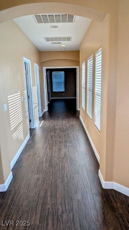 8159 Base Camp Ave, Las Vegas, NV 89178 - hallway with dark wood finished floors, baseboards, and arched walkways