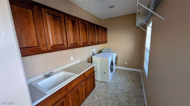 8159 Base Camp Ave, Las Vegas, NV 89178 - laundry room with cabinet space, washing machine and dryer, and light tile patterned floors