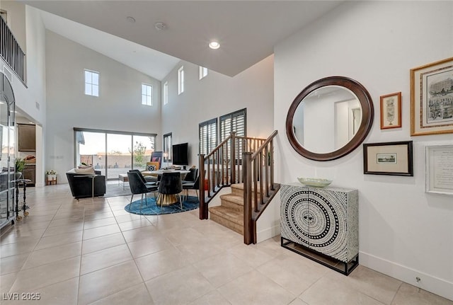 2669 Via Monet, Henderson, NV 89044 - stairs featuring high vaulted ceiling, baseboards, and tile patterned flooring