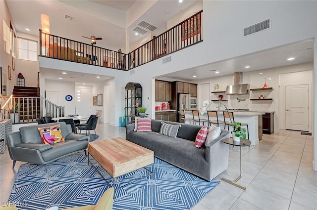 2669 Via Monet, Henderson, NV 89044 - living room featuring a high ceiling, stairs, and light tile patterned floors
