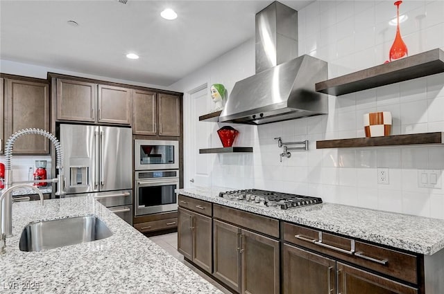2669 Via Monet, Henderson, NV 89044 - kitchen featuring open shelves, appliances with stainless steel finishes, wall chimney range hood, a sink, and tasteful backsplash