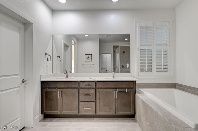 2669 Via Monet, Henderson, NV 89044 - full bath featuring a shower stall, double vanity, a garden tub, tile patterned flooring, and recessed lighting