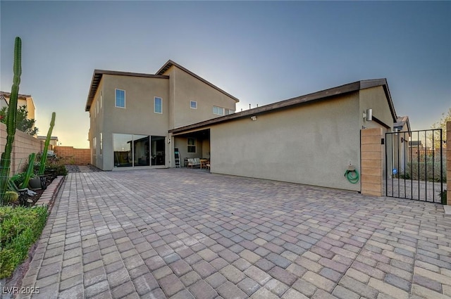 2669 Via Monet, Henderson, NV 89044 - back of property with stucco siding, a patio, and a gate