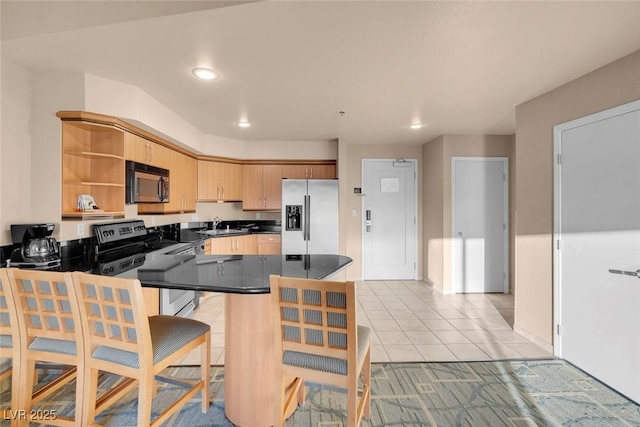 211 E Flamingo Rd Unit 1617, Las Vegas, NV 89169 - kitchen featuring stainless steel appliances, open shelves, dark countertops, recessed lighting, and a peninsula