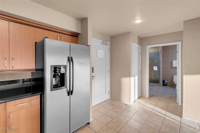 211 E Flamingo Rd Unit 1617, Las Vegas, NV 89169 - kitchen with stainless steel fridge with ice dispenser, light tile patterned flooring, dark countertops, baseboards, and recessed lighting