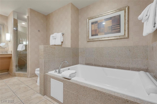 211 E Flamingo Rd Unit 1617, Las Vegas, NV 89169 - bathroom with toilet, a garden tub, a stall shower, tile patterned floors, and vanity