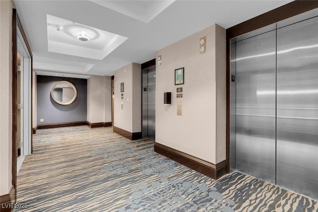 211 E Flamingo Rd Unit 1617, Las Vegas, NV 89169 - hallway with elevator, a tray ceiling, carpet, and baseboards