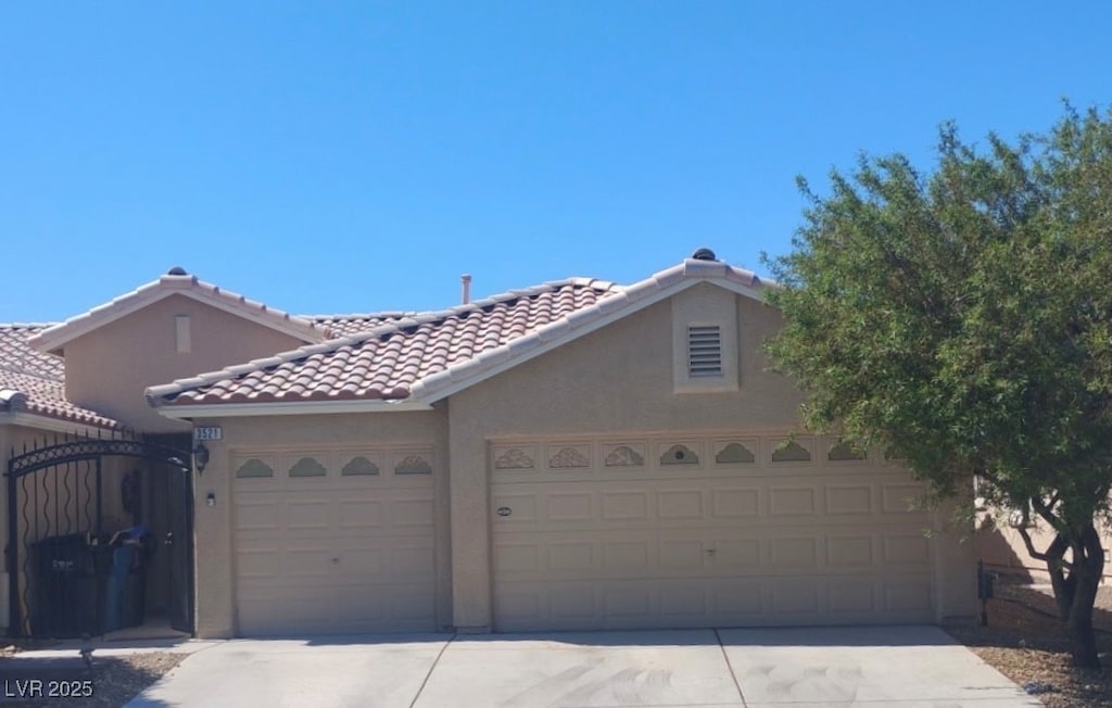 3521 Amish Ave, North Las Vegas, NV 89031 - view of front of property with concrete driveway, stucco siding, and a garage