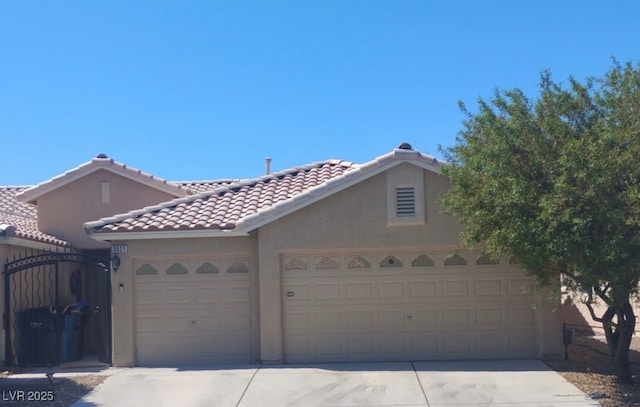 3521 Amish Ave, North Las Vegas, NV 89031 - view of front of property with concrete driveway, stucco siding, and a garage