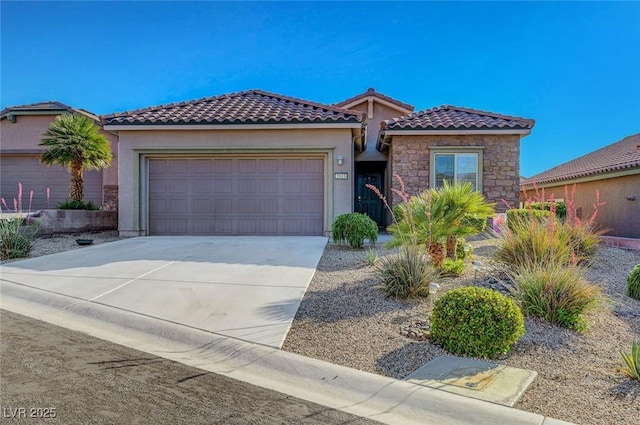2613 Velodrome Ct, Henderson, NV 89044 - mediterranean / spanish-style home featuring a garage, concrete driveway, stucco siding, stone siding, and a tile roof