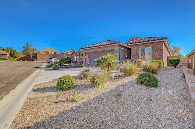 2613 Velodrome Ct, Henderson, NV 89044 - mediterranean / spanish-style home with stone siding, a tiled roof, driveway, a garage, and stucco siding