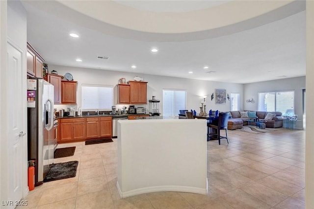 2613 Velodrome Ct, Henderson, NV 89044 - kitchen featuring stainless steel appliances, recessed lighting, open floor plan, a center island, and light tile patterned floors