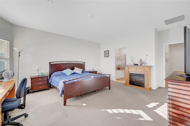 2613 Velodrome Ct, Henderson, NV 89044 - carpeted bedroom with a glass covered fireplace, ensuite bath, and a desk