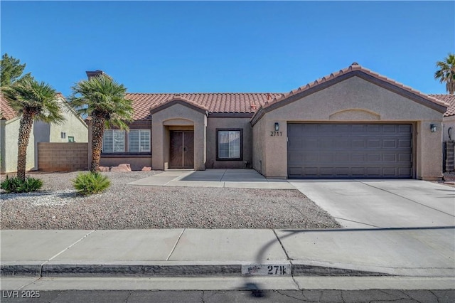 2711 Briarcliff Ave, Henderson, NV 89074 - mediterranean / spanish-style home with a tile roof, stucco siding, a garage, and driveway