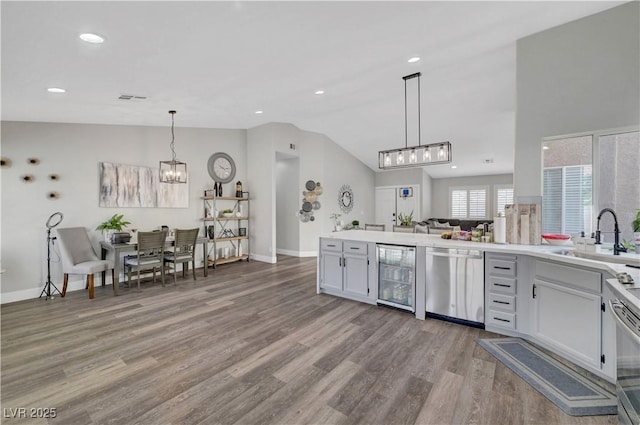 2711 Briarcliff Ave, Henderson, NV 89074 - kitchen featuring stainless steel dishwasher, beverage cooler, a sink, a chandelier, and lofted ceiling