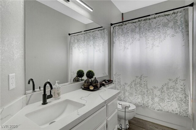 2711 Briarcliff Ave, Henderson, NV 89074 - bathroom with vanity, toilet, wood finished floors, and shower / tub combo