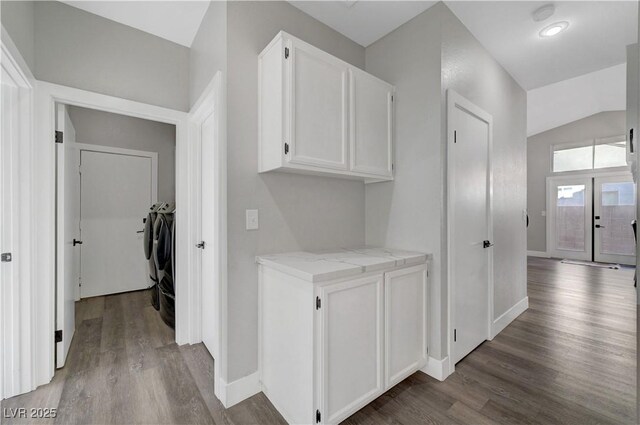 2711 Briarcliff Ave, Henderson, NV 89074 - hallway with washer and clothes dryer, wood finished floors, baseboards, and lofted ceiling