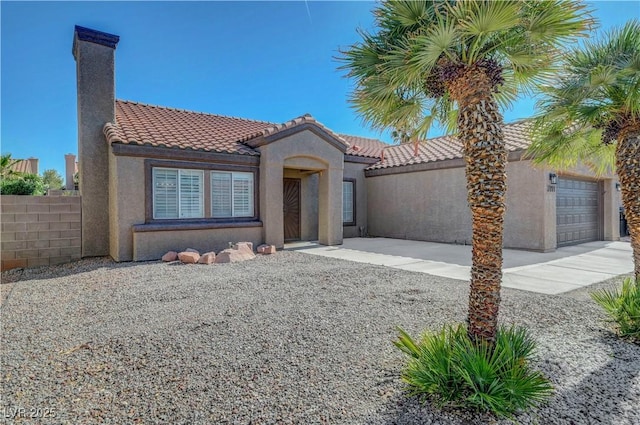 2711 Briarcliff Ave, Henderson, NV 89074 - mediterranean / spanish home with stucco siding, a tiled roof, a chimney, and an attached garage