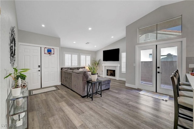 2711 Briarcliff Ave, Henderson, NV 89074 - living area featuring vaulted ceiling, wood finished floors, french doors, baseboards, and a fireplace