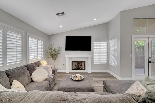 2711 Briarcliff Ave, Henderson, NV 89074 - living area with lofted ceiling, wood finished floors, baseboards, recessed lighting, and a premium fireplace