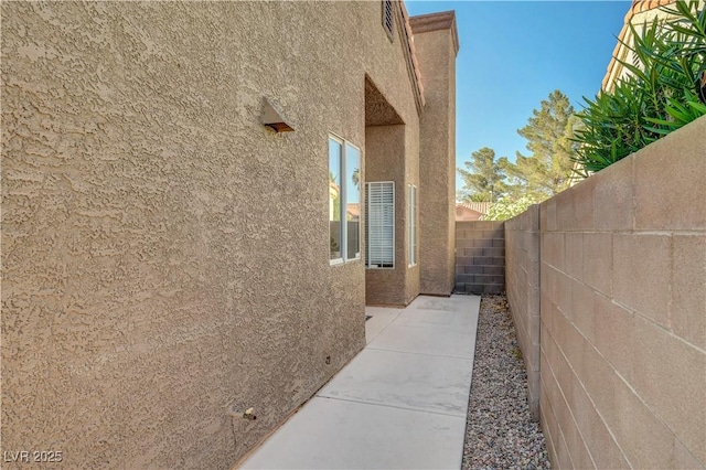 2711 Briarcliff Ave, Henderson, NV 89074 - view of side of home featuring stucco siding and a patio area
