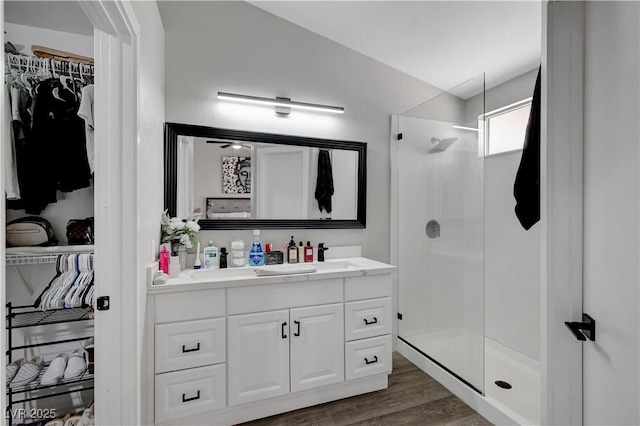 2711 Briarcliff Ave, Henderson, NV 89074 - full bath with vanity, a spacious closet, a shower stall, and wood finished floors