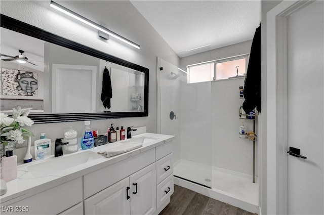 2711 Briarcliff Ave, Henderson, NV 89074 - full bath featuring a shower with door, double vanity, wood finished floors, and ceiling fan