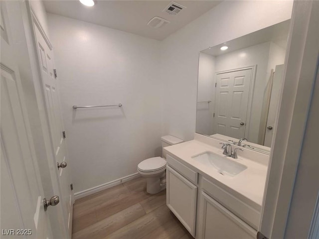 7332 N Decatur Blvd Unit 2, North Las Vegas, NV 89084 - bathroom featuring wood finished floors, vanity, toilet, baseboards, and recessed lighting