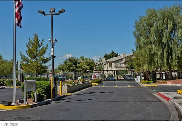 5710 E Tropicana Ave Unit 2178, Las Vegas, NV 89122 - view of asphalt street featuring curbs, a gated entry, and a gate