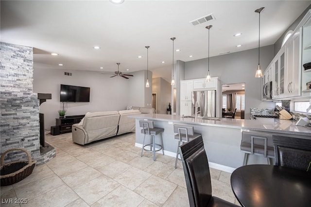 6417 Fisher Ave, Las Vegas, NV 89130 - kitchen featuring stainless steel appliances, ceiling fan, a peninsula, white cabinets, and glass insert cabinets