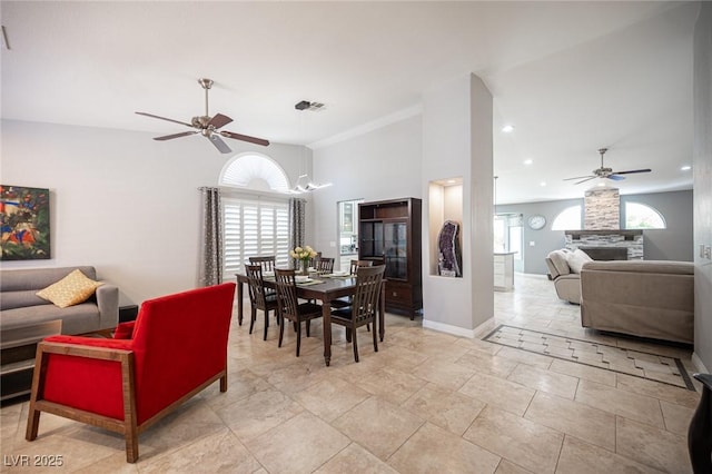 6417 Fisher Ave, Las Vegas, NV 89130 - dining space featuring a ceiling fan, baseboards, a fireplace, and recessed lighting