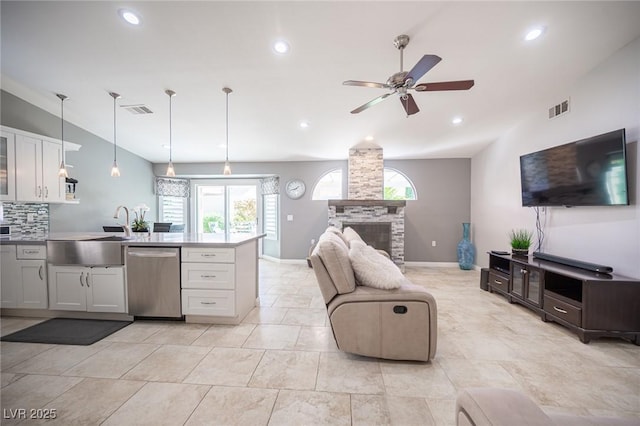 6417 Fisher Ave, Las Vegas, NV 89130 - kitchen featuring stainless steel dishwasher, a sink, lofted ceiling, a ceiling fan, and a peninsula