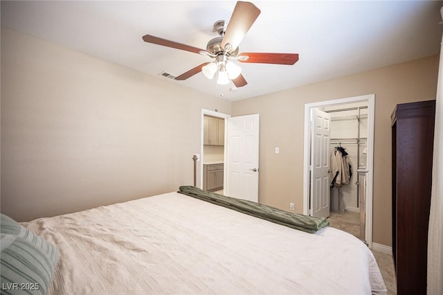 6417 Fisher Ave, Las Vegas, NV 89130 - bedroom featuring a walk in closet, ceiling fan, baseboards, and a closet