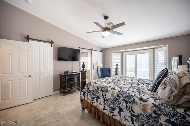 6417 Fisher Ave, Las Vegas, NV 89130 - bedroom featuring a barn door, vaulted ceiling, a ceiling fan, light tile patterned floors, and baseboards