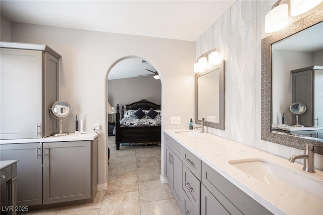 6417 Fisher Ave, Las Vegas, NV 89130 - ensuite bathroom with double vanity, a ceiling fan, and tile patterned flooring