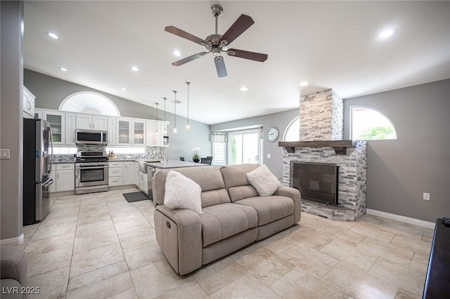 6417 Fisher Ave, Las Vegas, NV 89130 - living area featuring lofted ceiling, ceiling fan, a fireplace, recessed lighting, and baseboards