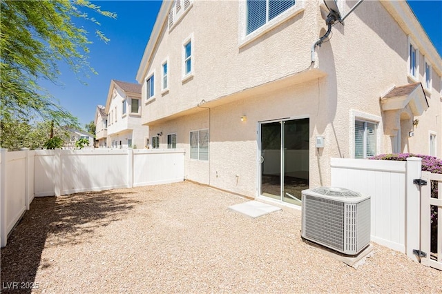 3041 Gary Cooper St Unit 103, Las Vegas, NV 89122 - rear view of property with central AC, stucco siding, and a fenced backyard