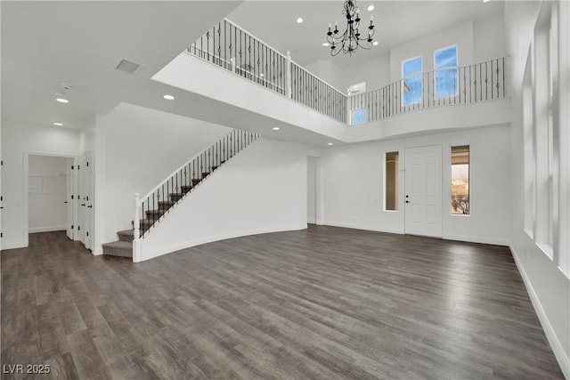 3221 Birdwatcher Ave, North Las Vegas, NV 89084 - unfurnished living room with stairs, recessed lighting, wood finished floors, a towering ceiling, and a chandelier