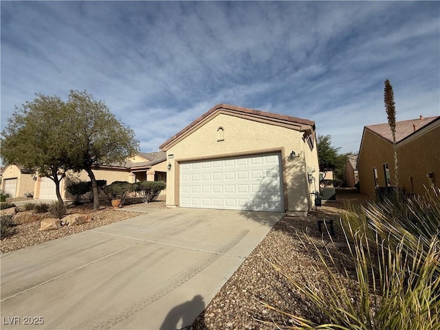 3508 Kittiwake Rd, North Las Vegas, NV 89084 - view of side of property with driveway, stucco siding, and a garage