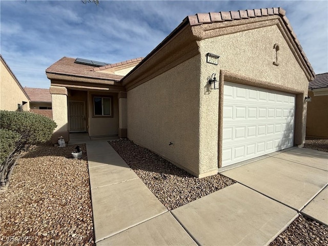 3508 Kittiwake Rd, North Las Vegas, NV 89084 - view of front of house with stucco siding, a tile roof, and roof mounted solar panels