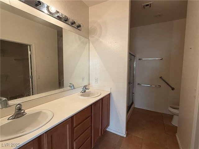 3508 Kittiwake Rd, North Las Vegas, NV 89084 - full bath with toilet, tile patterned flooring, double vanity, and a shower with door