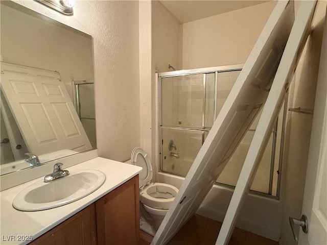3508 Kittiwake Rd, North Las Vegas, NV 89084 - full bath with a textured wall, shower / bath combination with glass door, toilet, and vanity
