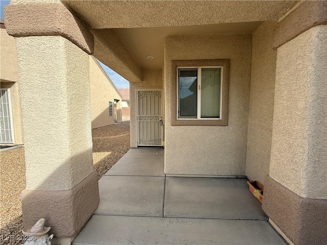 3508 Kittiwake Rd, North Las Vegas, NV 89084 - entrance to property with stucco siding and a patio