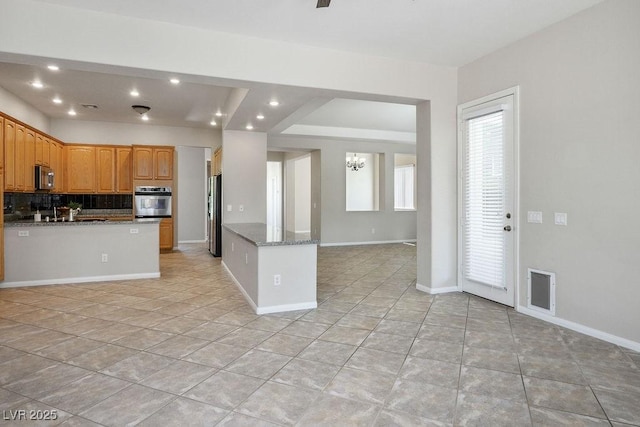 5017 Kaibab Forest Ave, Las Vegas, NV 89141 - kitchen with stainless steel appliances, backsplash, recessed lighting, open floor plan, and light tile patterned flooring