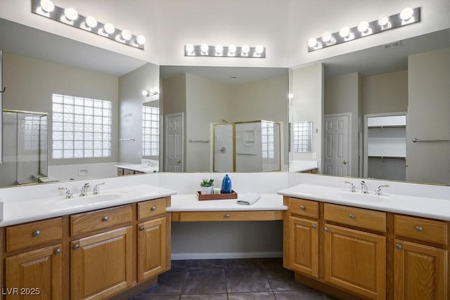 5017 Kaibab Forest Ave, Las Vegas, NV 89141 - full bath with a stall shower, two vanities, tile patterned flooring, and a closet